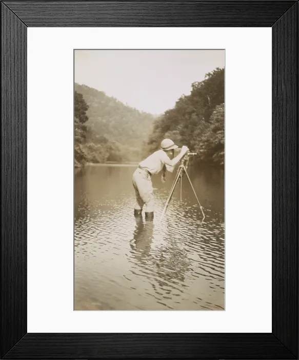 Framed Print : Marvin Breckinridge Patterson taking a photograph while standing in a river, 1935 Framed Print : Marvin Breckinridge Patterson taking a photograph while standing in a river, 1935