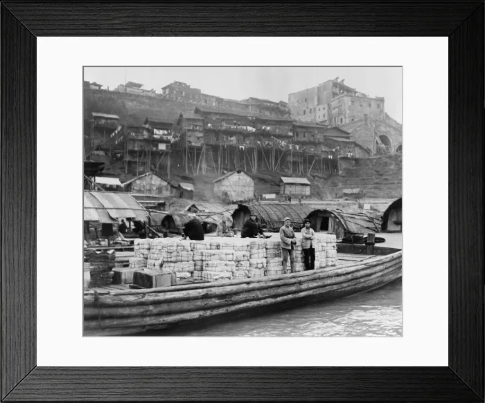 Framed Print : The riverfront of Chungking, China in Jan. 1944. As the inland wartime capital of China, it absorbed over a million refugees. Wooden barge is at dock with cotton bales Framed Print : The riverfront of Chungking, China in Jan. 1944. As the inland wartime capital of China, it absorbed over a million refugees. Wooden barge is at dock with cotton bales