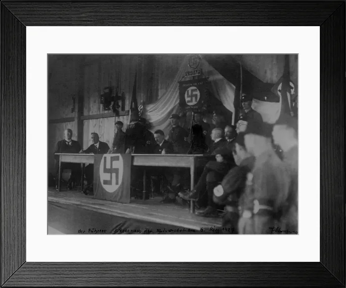 Framed Print : Adolf Hitler with members of the NSDAP sitting on stage, 1927. The figures siding beside Hitler had been crayoned over