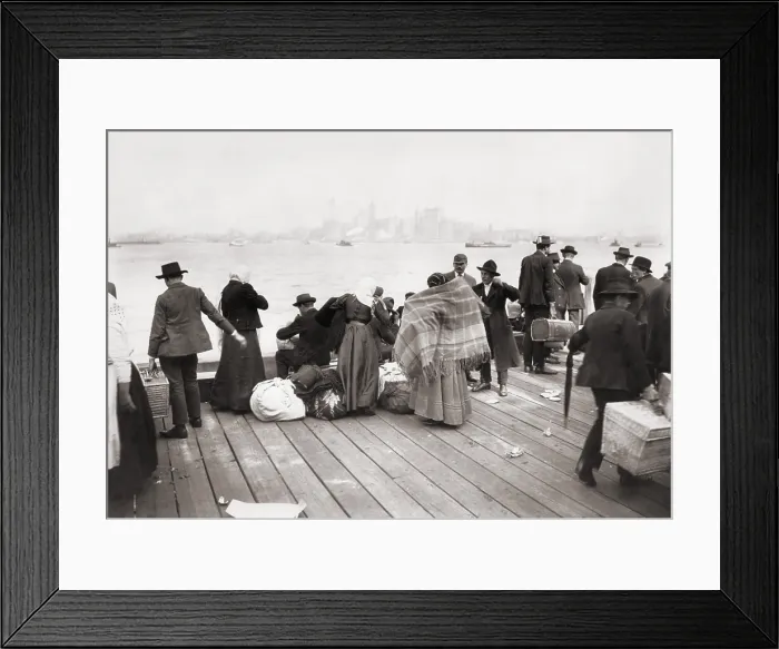 Framed Print : Immigrants waiting to be transferred by ferry from Ellis Island, on October 30, 1912. In the distance is their first destination, New York City Framed Print : Immigrants waiting to be transferred by ferry from Ellis Island, on October 30, 1912. In the distance is their first destination, New York City