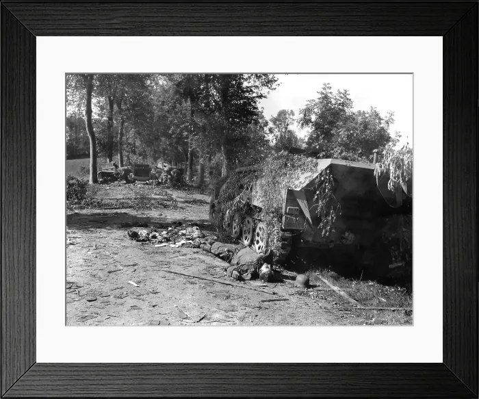 Framed Print : Dead German soldier lies beside a wrecked half-track near Mortain Framed Print : Dead German soldier lies beside a wrecked half-track near Mortain