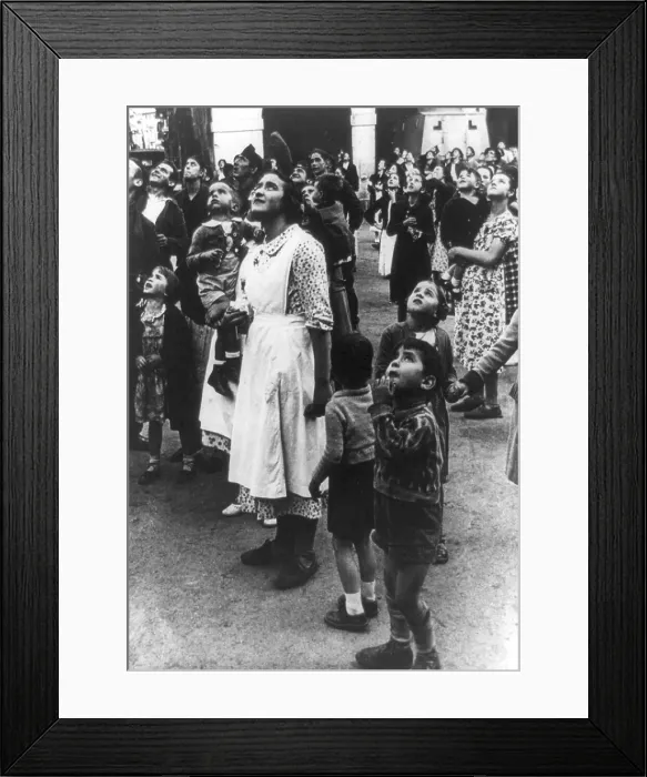Framed Print : Townspeople watch rebel aircraft flying overhead during the Spanish Civil War Framed Print : Townspeople watch rebel aircraft flying overhead during the Spanish Civil War
