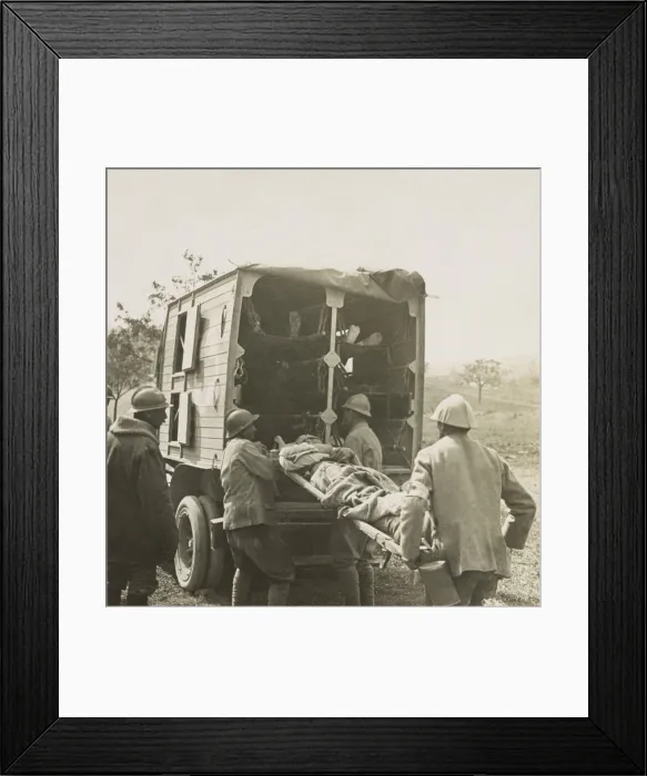 Framed Print : French soldiers load stretchers with wounded into motor ambulance for evacuation in World War 1. 1915-1918 (BSLOC_2017_1_14)