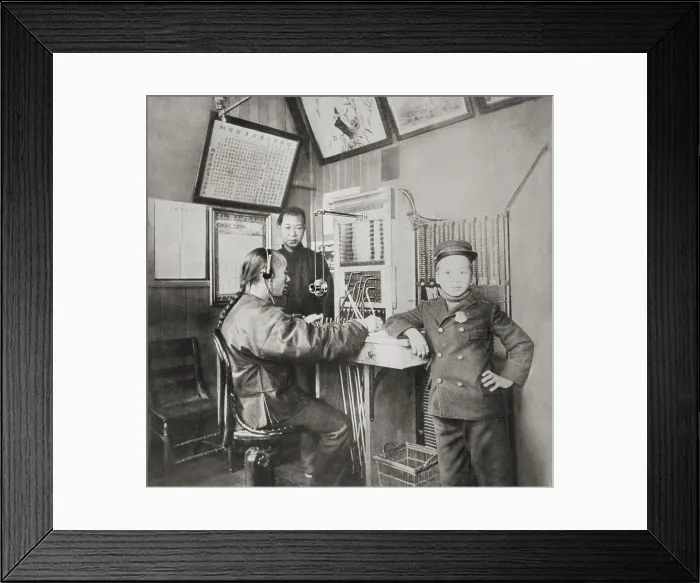 Framed Print : The first Chinese telephone operator in Chinatown, San Francisco, with a messenger boy standing by, 1910-1930 (BSLOC_2018_1_41) Framed Print : The first Chinese telephone operator in Chinatown, San Francisco, with a messenger boy standing by, 1910-1930 (BSLOC_2018_1_41)