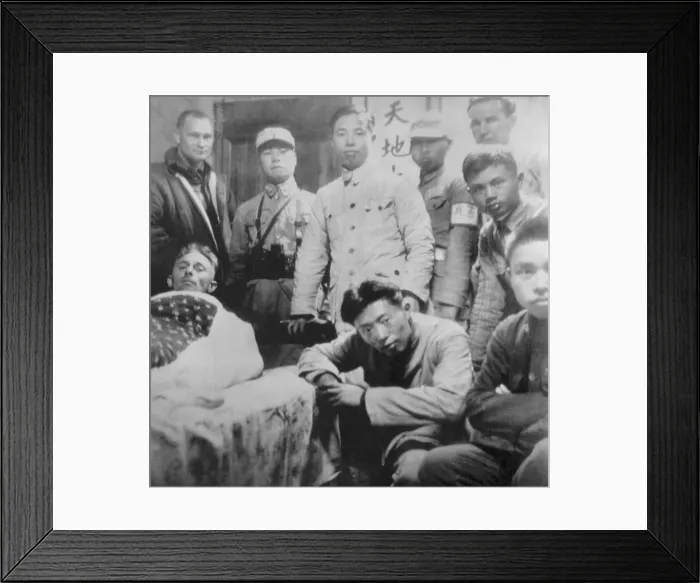 Framed Print : U.S. Doolittle Raider with his Chinese friends. An American flier, injured in a parachute jump after the April 8, 1942 air raid, lies on a cot in a Chinese home Framed Print : U.S. Doolittle Raider with his Chinese friends. An American flier, injured in a parachute jump after the April 8, 1942 air raid, lies on a cot in a Chinese home