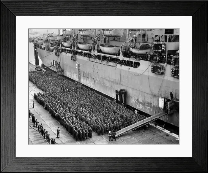 Framed Print : Hundreds of German POWs, under guard beside an Allied troop ship. The peace time ocean liner will transport the prisoners to camps in Britain or the United States Framed Print : Hundreds of German POWs, under guard beside an Allied troop ship. The peace time ocean liner will transport the prisoners to camps in Britain or the United States