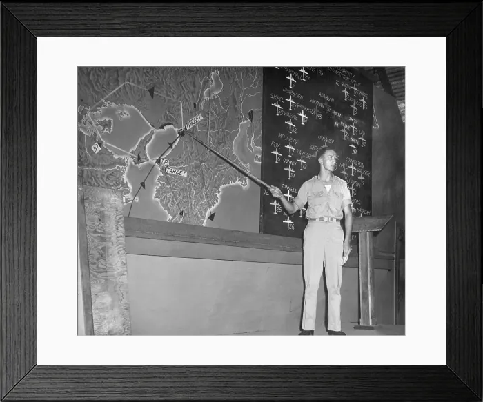 Framed Print : Planning a bombing raid on Japan from Saipan in the Marianas Islands. Capt. Glenn McClure, 500th Bombardment Group, 20th Air Force, pointing to targets on a map of Japan