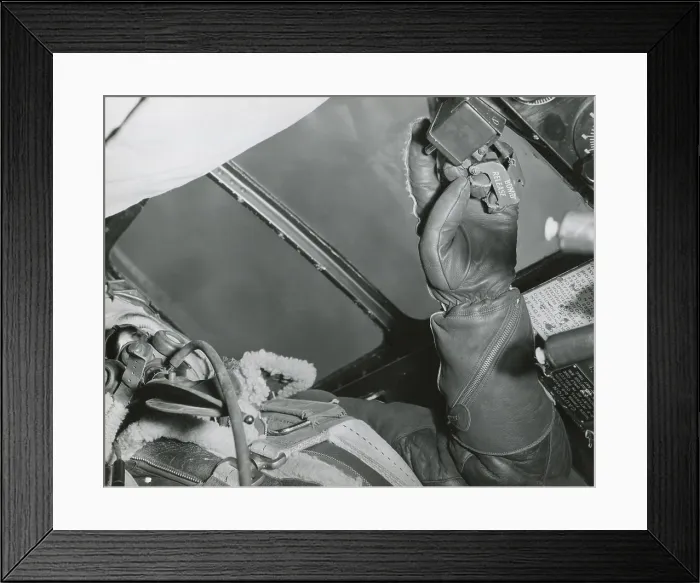 Framed Print : American Bombardier with his hand on the Bomb Release over Germany in 1943. His fleece lined leather gloves and jacket protect him for the cold at high altitudes