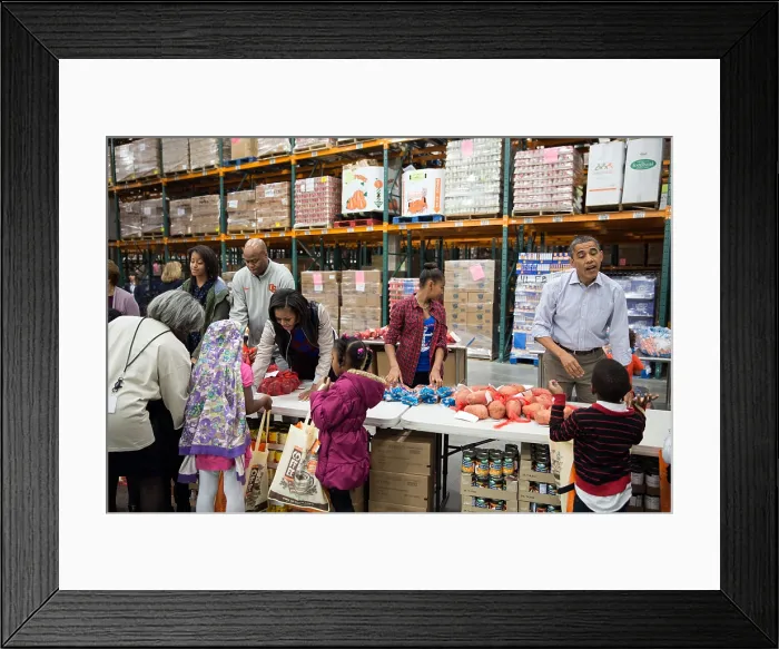 Framed Print : The First Family works at a service project at the Capital Area Food Bank in Washington, D.C. Nov. 21, 2012