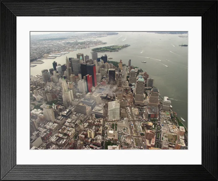 Framed Print : Aerial view of Lower Manhattan and New York Harbor on Sept. 27, 2001. In photo center, the Ground Zero site is still smoldering 15 days after September 11, 2001 terrorist attacks