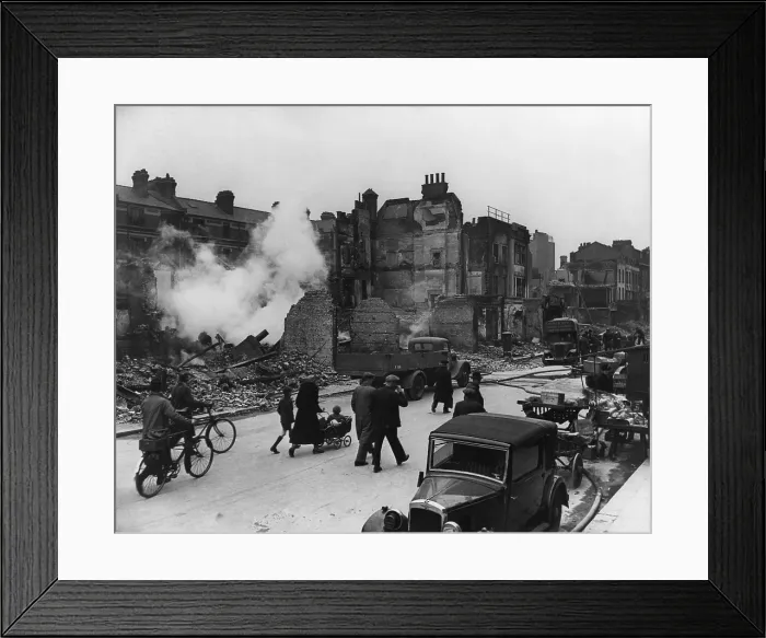 Framed Print : World War 2, Battle of Britain. Londoners walk through a ruined street with their bicycles and a baby carriage during the Blitz. Ca. 1940-41. (BSLOC_2013_11_91)