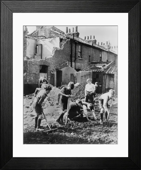 Framed Print : World War 2, Battle of Britain. Young boys with pitchforks and rakes start a garden next to buildings damaged by air raids. Between 1940-1945. (BSLOC_2013_11_92) Framed Print : World War 2, Battle of Britain. Young boys with pitchforks and rakes start a garden next to buildings damaged by air raids. Between 1940-1945. (BSLOC_2013_11_92)