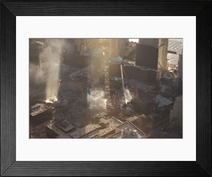 Framed Print : Aerial view of Ground Zero from the northeast as the late afternoon sun illuminates the smoke. Oct. 8, 2001