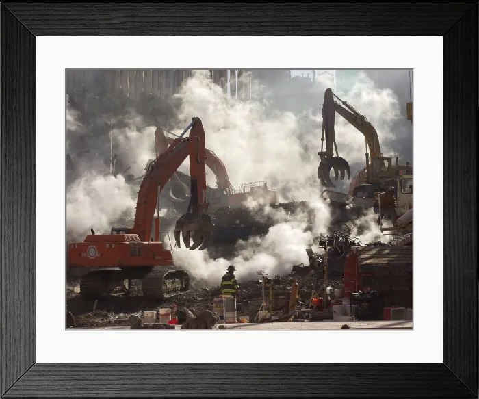 Framed Print : Ground Zero still smolders as recovery operations continue a month after the terrorist attack. Oct. 10, 2001. Excavating equipment works in coordination with rescue workers