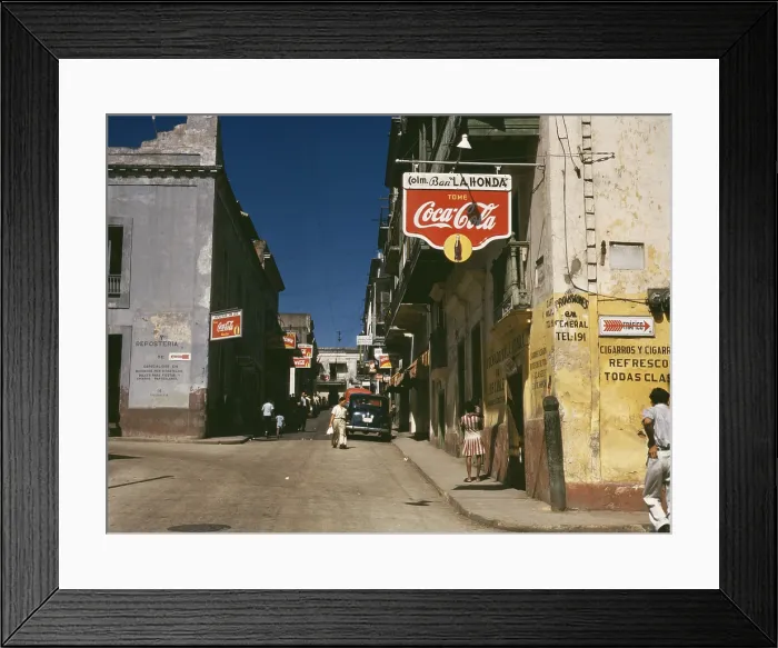 Framed Print : Street in San Juan Puerto Rico where many business advertise with Coca Cola signs. Dec. 1941
