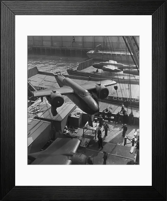 Framed Print : Lend Lease war materials for England. American twin-engine bombers are hoisted aboard ship in an unnamed American port. 1941-44 Framed Print : Lend Lease war materials for England. American twin-engine bombers are hoisted aboard ship in an unnamed American port. 1941-44