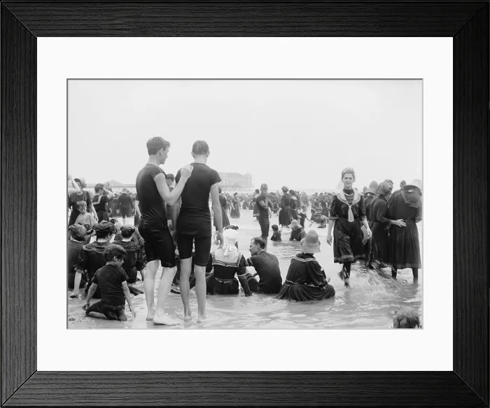 Framed Print : Men, women, and children enjoying the surf at Atlantic City, New Jersey, c. 1890-1900. Most women wear a middy style swimming dress with fill long sleeves and stockings Framed Print : Men, women, and children enjoying the surf at Atlantic City, New Jersey, c. 1890-1900. Most women wear a middy style swimming dress with fill long sleeves and stockings