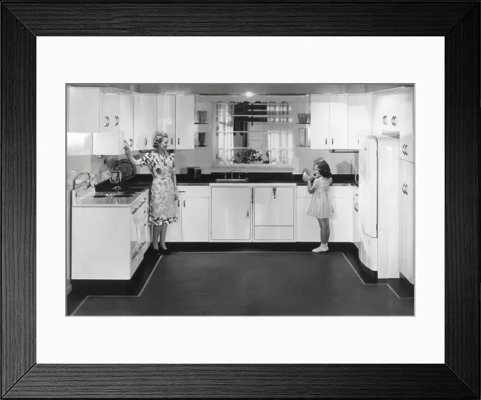 Framed Print : Modern electric kitchen with a stove and refrigerator. An electric dishwasher is to right of the sink. The all metal cabinets complete advanced design. Ca. 1950 Framed Print : Modern electric kitchen with a stove and refrigerator. An electric dishwasher is to right of the sink. The all metal cabinets complete advanced design. Ca. 1950