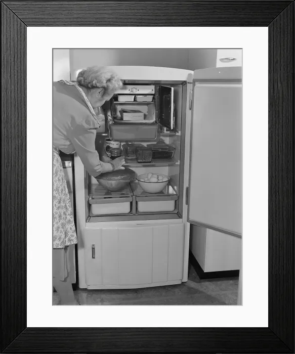 Framed Print : Interior of a 1940's refrigerator has a small freezer section. The most perishable foods were stored near the freezer. The bottom compartment contained the refrigeration unit Framed Print : Interior of a 1940's refrigerator has a small freezer section. The most perishable foods were stored near the freezer. The bottom compartment contained the refrigeration unit