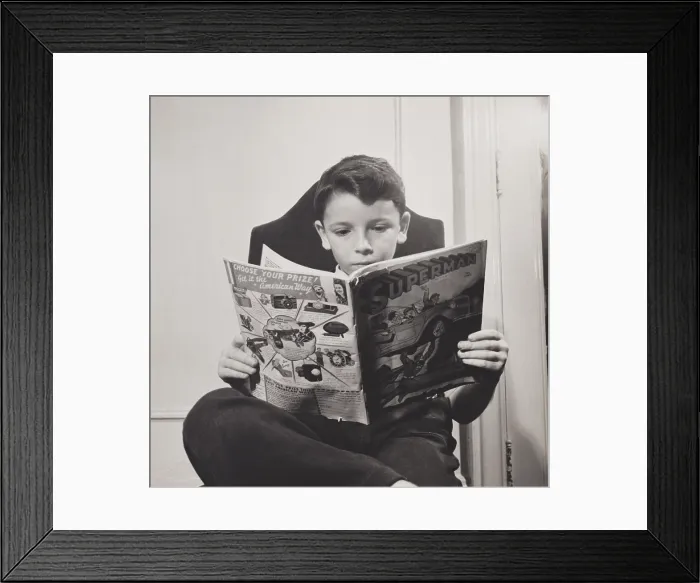 Framed Print : German refugee boy reading a Superman comic at the N.Y. Children's Colony school in 1942. (BSLOC_2014_13_164) Framed Print : German refugee boy reading a Superman comic at the N.Y. Children's Colony school in 1942. (BSLOC_2014_13_164)