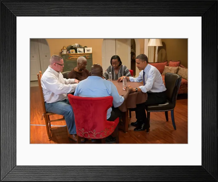 Framed Print : President Barack Obama prays with the family of school teacher Tiffany Santana in Falls Church, Va. Dec. 6, 2012