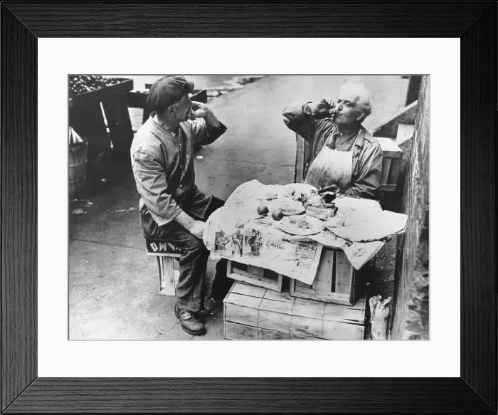Framed Print : Two street vendors have lunch at a makeshift table of wooden crates covered with newspaper. New York, Aug. 1946. (BSLOC_2014_13_172)