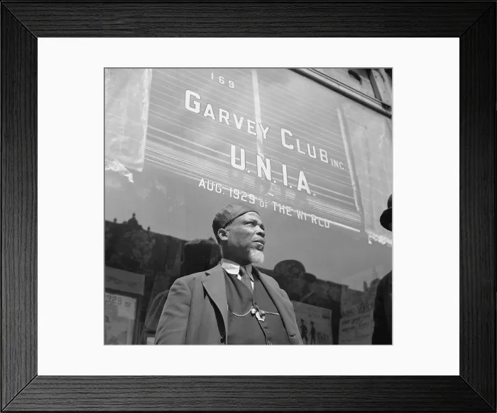 Framed Print : A Garveyite in front of the Garvey Club storefront in Harlem. U.N.I.A. (Universal Negro Improvement Association) founded by Marcus Garvey. April 1943 photo by Gordon Parks Framed Print : A Garveyite in front of the Garvey Club storefront in Harlem. U.N.I.A. (Universal Negro Improvement Association) founded by Marcus Garvey. April 1943 photo by Gordon Parks