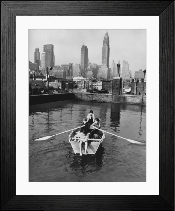 Framed Print : Four young members of the Madison Square Boy's Club rowing a boat in a rooftop pool. Manhattan skyscrapers are in the background, Feb. 1950. (BSLOC_2014_13_177) Framed Print : Four young members of the Madison Square Boy's Club rowing a boat in a rooftop pool. Manhattan skyscrapers are in the background, Feb. 1950. (BSLOC_2014_13_177)