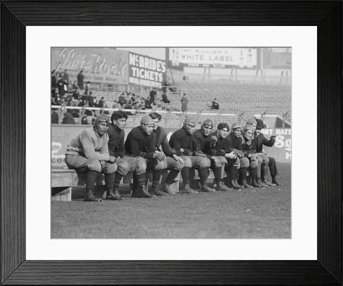 Framed Print : Carlisle Indian School, football players on the bench, during a game at the Polo Grounds, NYC, 1909