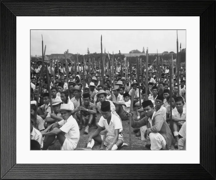 Framed Print : Young Indonesian men seated on ground holding sharpened bamboo poles Framed Print : Young Indonesian men seated on ground holding sharpened bamboo poles