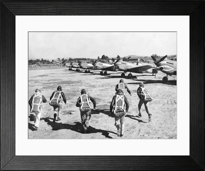 Framed Print : U.S. Flying Tiger pilots run to their fighter planes at an advanced U.S. base in China. They will pursue Japanese bombers conducting an air raid in their area. They are U.S