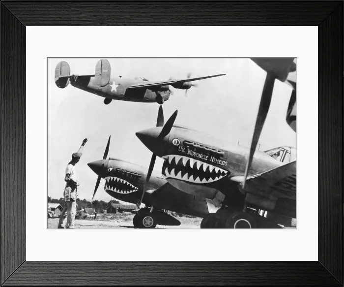 Framed Print : An American B-24 Liberator bomber takes off from an advanced U.S. base in China. On the ground are shark nosed P-40 fighters of the Flying Tigers, U.S Framed Print : An American B-24 Liberator bomber takes off from an advanced U.S. base in China. On the ground are shark nosed P-40 fighters of the Flying Tigers, U.S