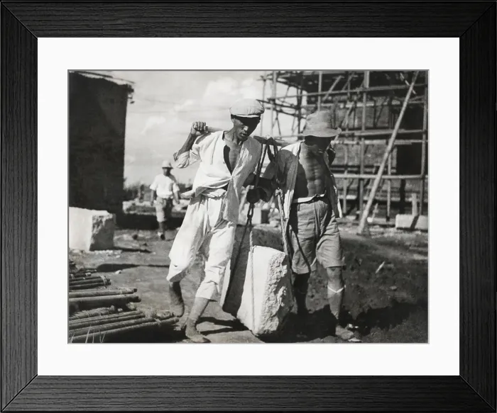 Framed Print : Two Chinese men work together to life a large stone on a construction site. They use traditional, pre-industrial lifting techniques. Ca. 1930-40s. - (BSLOC_2014_15_151) Framed Print : Two Chinese men work together to life a large stone on a construction site. They use traditional, pre-industrial lifting techniques. Ca. 1930-40s. - (BSLOC_2014_15_151)