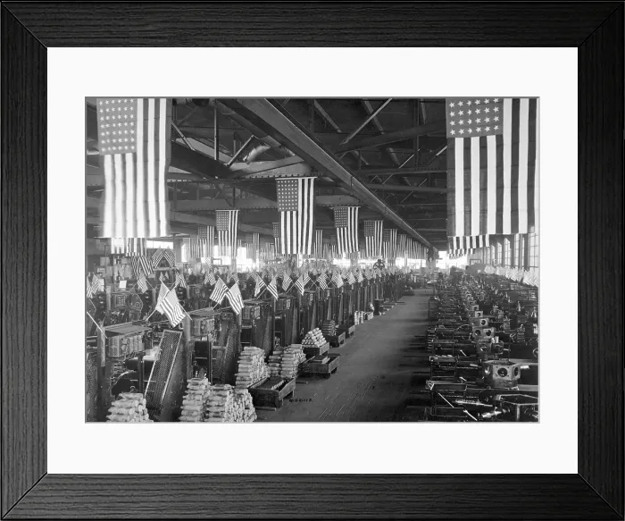 Framed Print : American flags decorate the machine shop for 3 inch artillery shells at the Bethlehem Steel Company during World War I. Ca. 1918