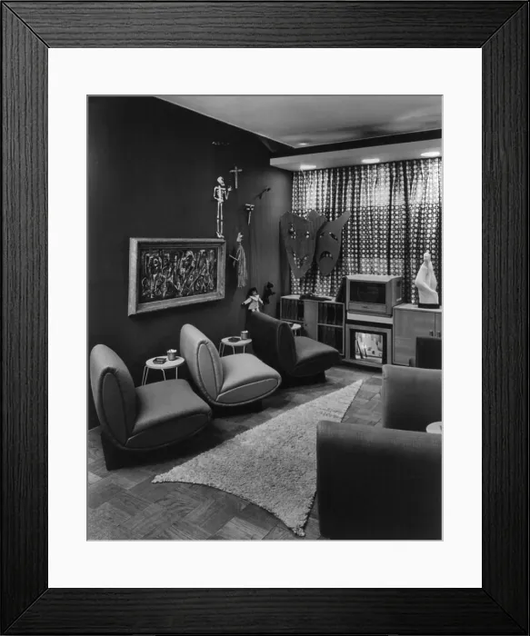 Framed Print : Modern designer television room displayed in a New York City department store in 1949. Positioned seats and an arrow shaped carpet emphasize the floor level TV