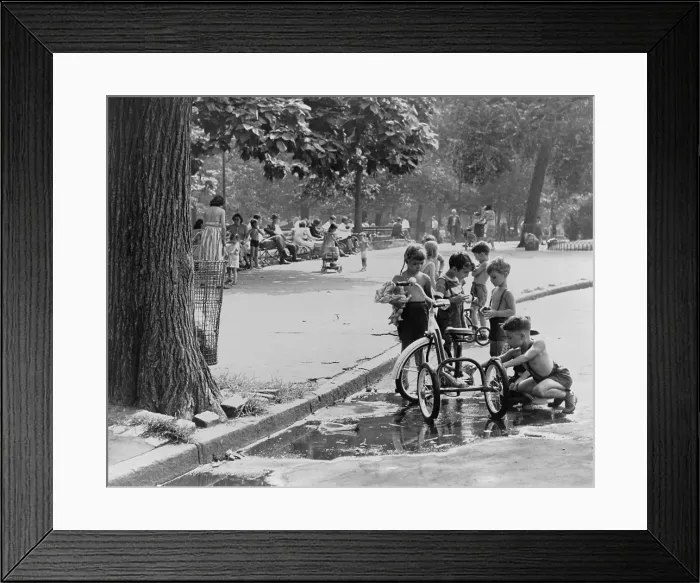 Framed Print : Children with tricycles play near a puddle in Washington Square Park. New York City Aug. 3, 1948. (BSLOC_2014_13_167)