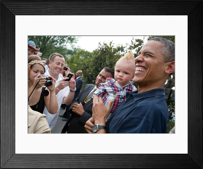 Framed Print : President Barack Obama holds a baby during an White House Independence Day celebration. July 4, 2012. (BSLOC_2015_13_146) Framed Print : President Barack Obama holds a baby during an White House Independence Day celebration. July 4, 2012. (BSLOC_2015_13_146)