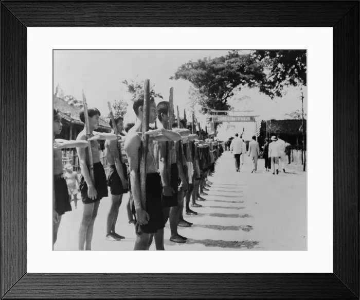 Framed Print : Barefoot villagers perform training drills using bamboo rifles at a French Legionnaire outpost. Batri, French Indochina, 1951. - (BSLOC_2014_15_187)