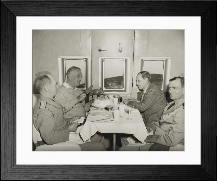 Framed Print : Pres. Franklin Roosevelt cuts into his birthday cake aboard a plane. Jan. 30, 1943. On his 61st birthday he was returning from the Casablanca Conference with Adm