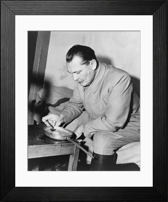 Framed Print : War criminal Hermann Goering eating gruel from a metal pan in prison. He was the highest ranking Nazi to be convicted at the Nuremberg Trials. Nov. 1945-Oct. 1946 Framed Print : War criminal Hermann Goering eating gruel from a metal pan in prison. He was the highest ranking Nazi to be convicted at the Nuremberg Trials. Nov. 1945-Oct. 1946