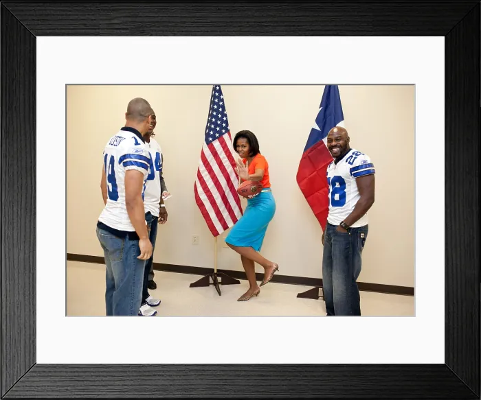 Framed Print : First Lady Michelle Obama strikes the Heisman pose while greeting Dallas Cowboys football players. L-R: Miles Austin, DeMarcus Ware, and Felix Jones. The players joined Mrs Framed Print : First Lady Michelle Obama strikes the Heisman pose while greeting Dallas Cowboys football players. L-R: Miles Austin, DeMarcus Ware, and Felix Jones. The players joined Mrs