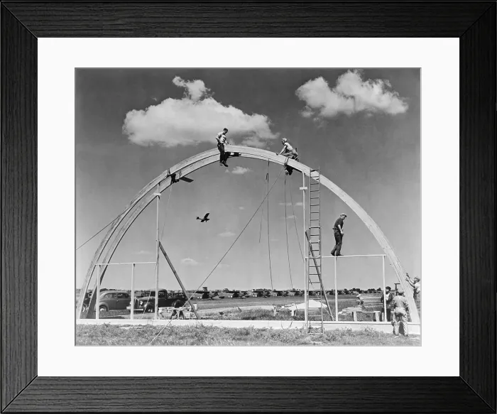 Framed Print : Construction workers on airplane hangar with prefabricated Rilco glued laminated wooden arches. The arch of the Morey Airplane Hangar has a span of 70 feet Framed Print : Construction workers on airplane hangar with prefabricated Rilco glued laminated wooden arches. The arch of the Morey Airplane Hangar has a span of 70 feet