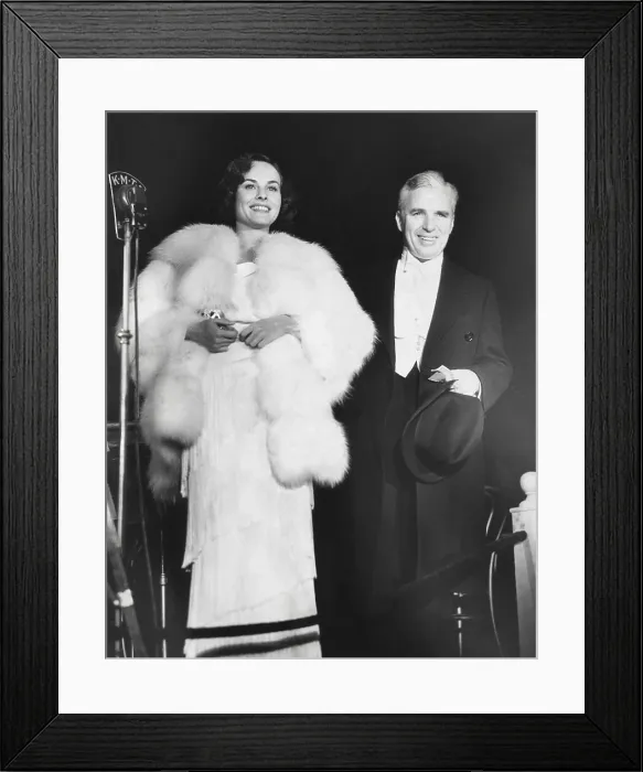 Framed Print : Charlie Chaplin attends the premiere of MODERN TIMES with his leading lady, Paulette Goddard. The film had no dialogue but employed sound effects and was a big success