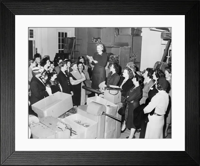 Framed Print : Vivien Kellems speaking to women in her Saugatuck, Connecticut, Cable-Grip factory. She is reading from a statute book, possibly on tax law