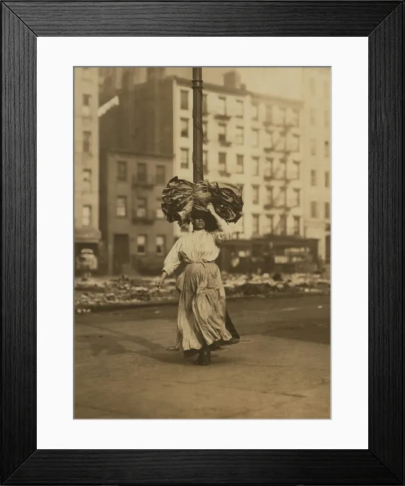 Framed Print : Italian woman carrying heavy bundle of clothing on her head Near Astor Place, New York City. She will sew the garments at home for low wages Framed Print : Italian woman carrying heavy bundle of clothing on her head Near Astor Place, New York City. She will sew the garments at home for low wages