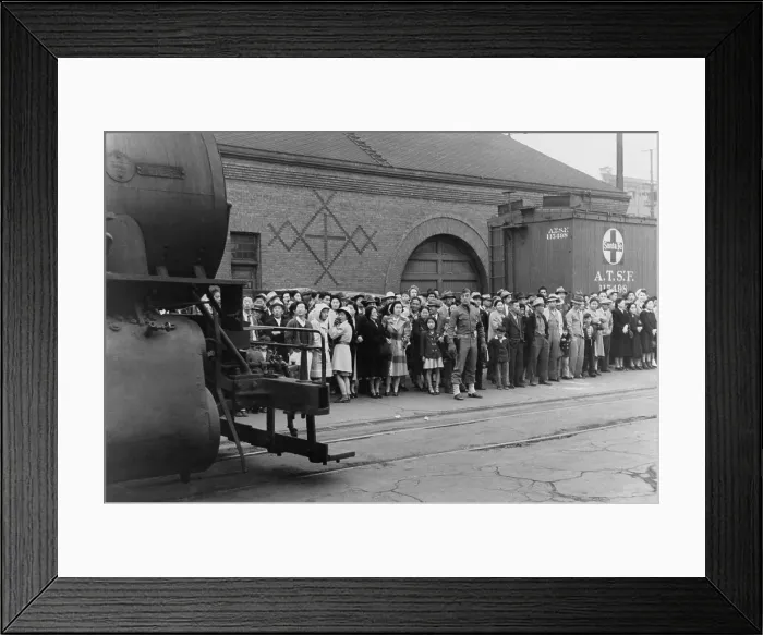 Framed Print : Japanese Americans at a train station as the U.S. Military supervises their transport to Owens Valley Assembly center for internment during World War II