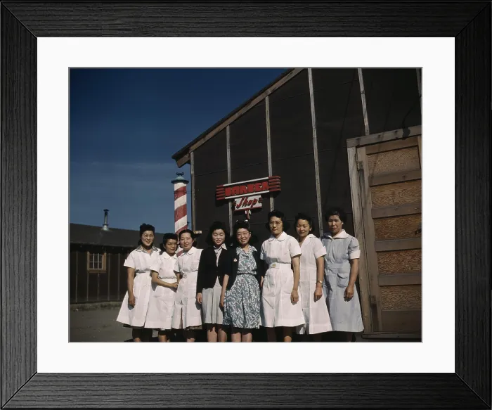 Framed Print : Eight Japanese American women pose for a photograph in front of a camp barber shop of Tule Lake Relocation Center, the largest