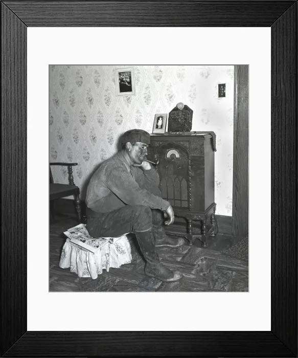 Framed Print : Polish-American miner, covered with coal dust, listens to the radio after working the night shift in Westover, West Virginia. 1938 photo by Marion Post Wolcott