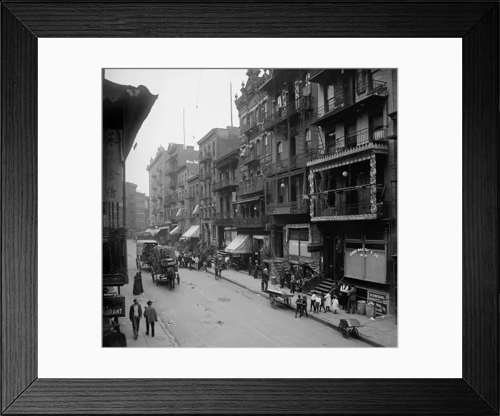 Framed Print : Mott Street in New York City's Chinatown presents a cosmopolitan scene mixing Asian and American-European dress and faces