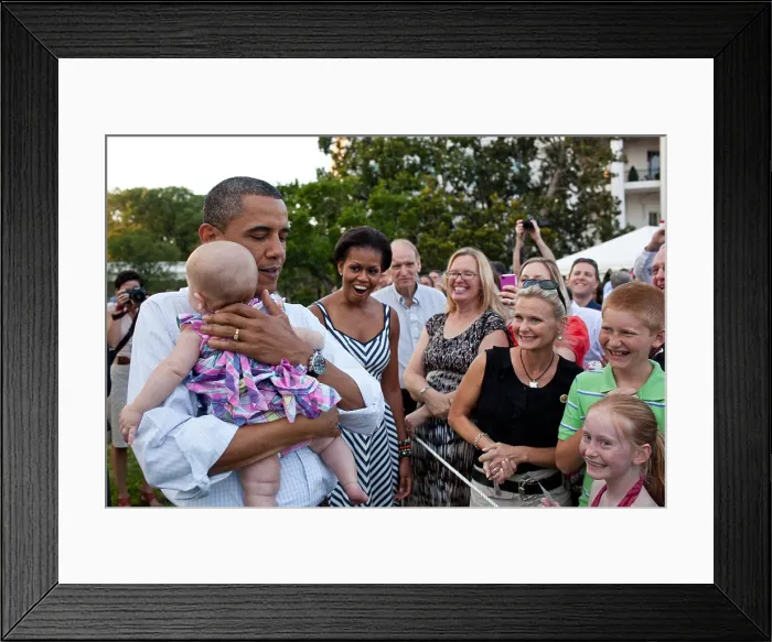 Framed Print : President Barack Obama soothes a crying baby at the Congressional Picnic